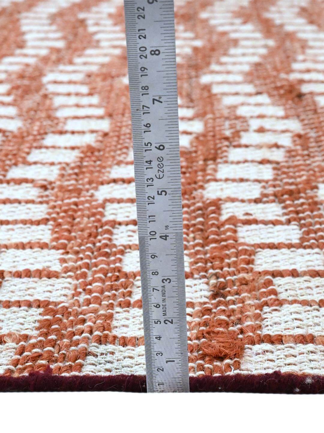 Measuring the pile height of a woven rug