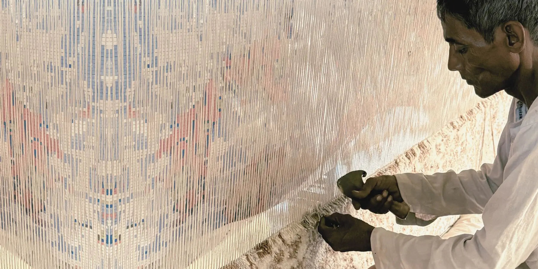 artisan making hand knotted wool carpet in bhadohi