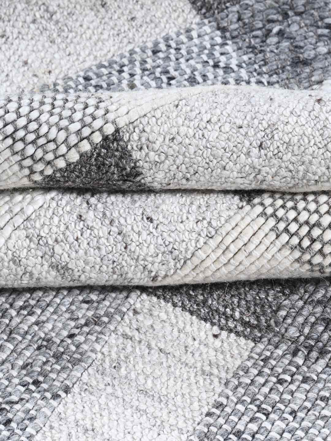 Close-up of textured gray and white rugs